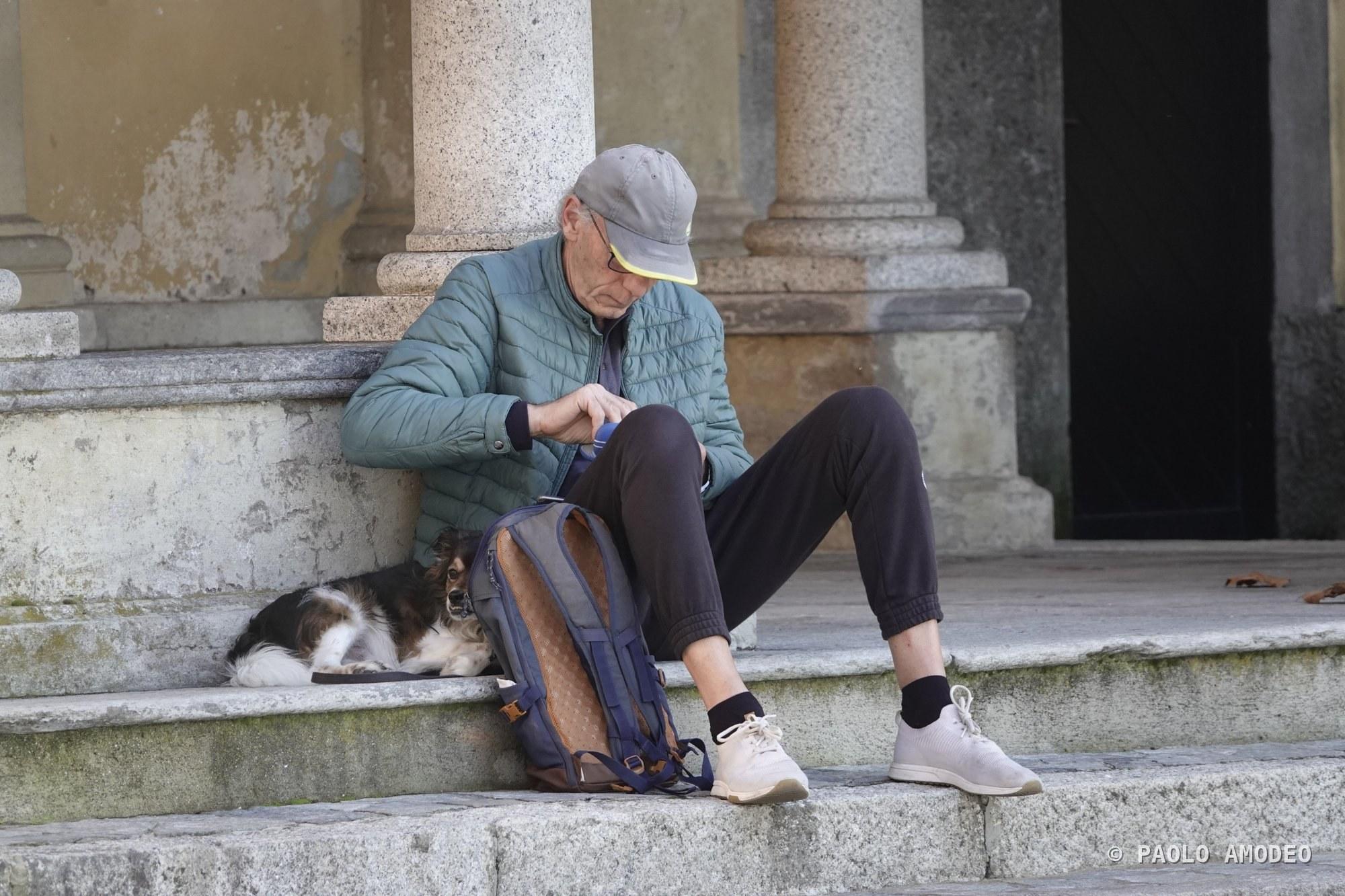 Sosta sui gradini con chitarra e un gatto